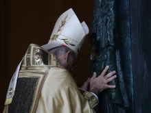 Cardinal Baldassare Reina ceremonially pushes open the Holy Door at St. John Lateran on Dec. 29, 2024.