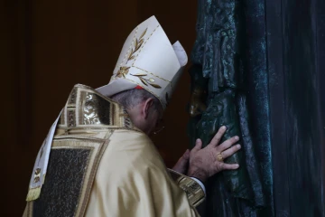 Cardinal Baldassare Reina ceremonially pushes open the Holy Door at St. John Lateran on Dec. 29, 2024.