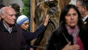 A Sister of the Missionaries of Charity touches the bronze Holy Door at the papal basilica during its opening for the 2025 Jubilee Year. The religious sister, wearing the distinctive white and blue habit of the order founded by Mother Teresa, joins other faithful in this traditional gesture of devotion as they pass through the ceremonial door on Jan. 1, 2025.