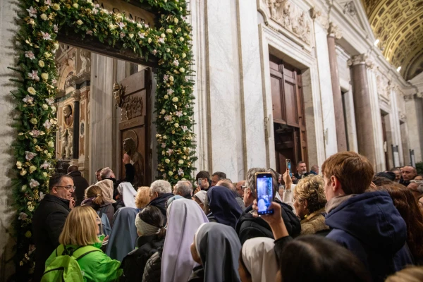 Faithful gather at the flower-adorned Holy Door of the Basilica of St. Mary Major in Rome on Jan. 1, 2025, as the jubilee year gets underway. Credit: Daniel Ibáñez/CNA