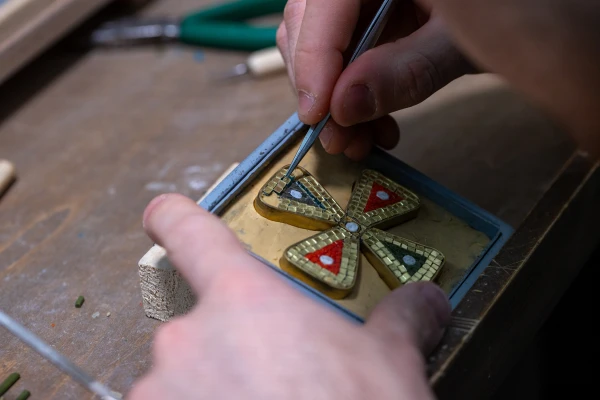 A student composes a mosaic cross at the School of Arts and Crafts of the Fabbrica di San Pietro, Friday, Feb. 14, 2025. Credit: Daniel Ibáñez/CNA