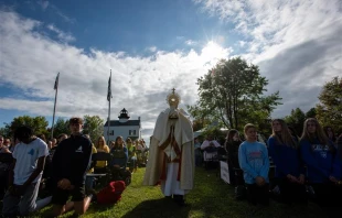 Youth adore Christ in the Eucharist at the "Journey: Why did they come?" youth rally on St. Clements Island, Maryland, Sept. 30, 2023. The altar used during the rally was specially made by local craftsmen to be used for Masses on the island. Credit: Jeffrey Bruno