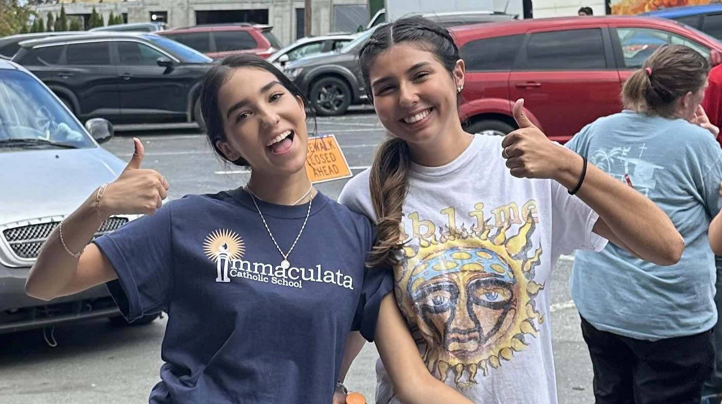 Volunteers smile while distributing relief supplies at Immaculata Catholic School in Hendersonville, North Carolina, October 2024.?w=200&h=150