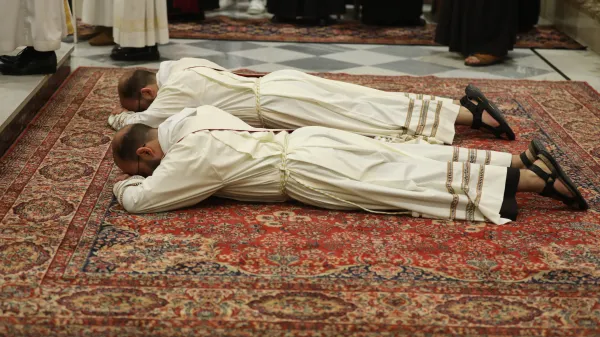 The twins George and Johnny Jallouf, friars of the Custody of the Holy Land, during their priestly ordination on July 6, 2024, at the Franciscan church in Aleppo, Syria, their hometown. One of the most moving moments of the rite is when the candidates for priesthood prostrate themselves, face down, in a gesture of humility, while everyone prays for them by singing the Litany of the Saints. Credit: Photo courtesy of the Tawk Center