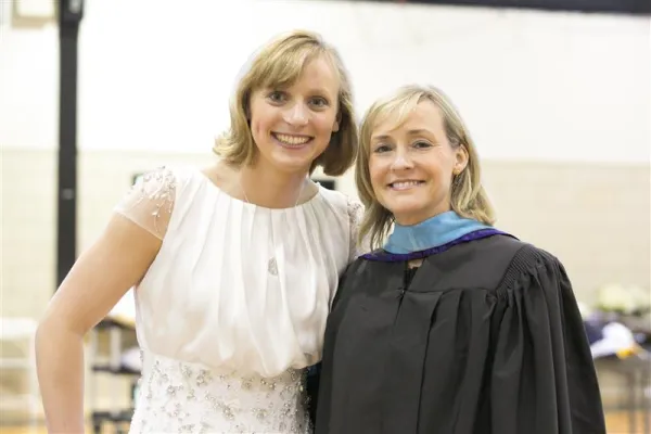 Katie Ledecky poses alongside her principal, Catherine Karrels, at her high school graduation in 2015. Credit: Stone Ridge of the Sacred Heart School