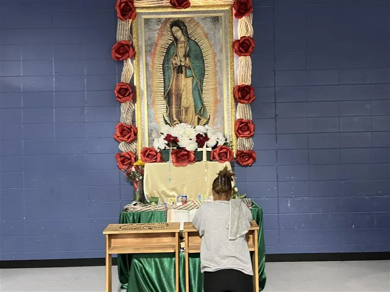 A migrant woman prays in front of an image of Our Lady of Guadalupe at a migrant shelter in McAllen, Texas, run by Catholic Charities of the Rio Grande Valley.?w=200&h=150