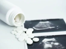 A pro-abortion activist displays abortion pills as she counter-protests during a pro-life rally on March 25, 2023, in New York City.