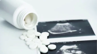 A pro-abortion activist displays abortion pills as she counter-protests during a pro-life rally on March 25, 2023, in New York City.