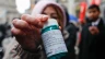 A pro-abortion activist displays abortion pills as she counter-protests during a pro-life rally on March 25, 2023, in New York City.