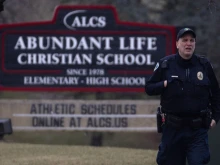 A police officer stands guard in front of Abundant Life Christian School on Dec. 16, 2024, in Madison, Wisconsin. According to reports, a student and teacher were shot and killed at the school earlier today, and the suspected shooter was found dead at the scene.