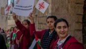 Children welcome the custos of the Holy Land, Father Francesco Patton, upon his entrance into Bethlehem on Nov. 30, 2024, for the beginning of Advent. The custos’ entry was festive, but at the same time, it was impossible to ignore the echoes of war. The children were holding signs with messages of peace and solidarity for those suffering due to the war.