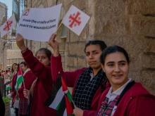 Children welcome the custos of the Holy Land, Father Francesco Patton, upon his entrance into Bethlehem on Nov. 30, 2024, for the beginning of Advent. The custos’ entry was festive, but at the same time, it was impossible to ignore the echoes of war. The children were holding signs with messages of peace and solidarity for those suffering due to the war.