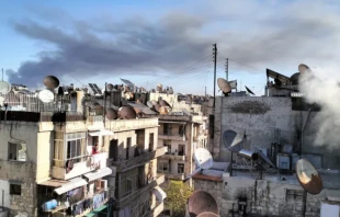 Smoke of war rises over a residential area in Aleppo. On Dec. 1, 2024, the Franciscan complex of the Terra Santa College in Aleppo was hit by a strike. No casualties were reported. Credit: ACI MENA