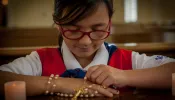 American Heritage “Tenderheart” girl prays the rosary.