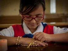 American Heritage “Tenderheart” girl prays the rosary.