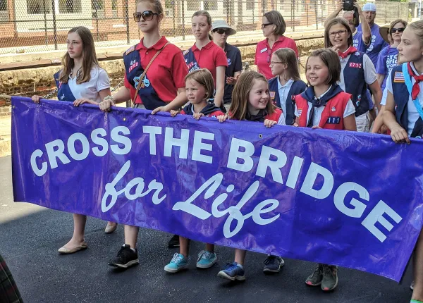 Girls from Cincinnati-area troops carry the banner for the annual Cross the Bridge for Life event sponsored by the Diocese of Covington, Kentucky, just across the river from Cincinnati. Credit: Photo courtesy of American Heritage Girls