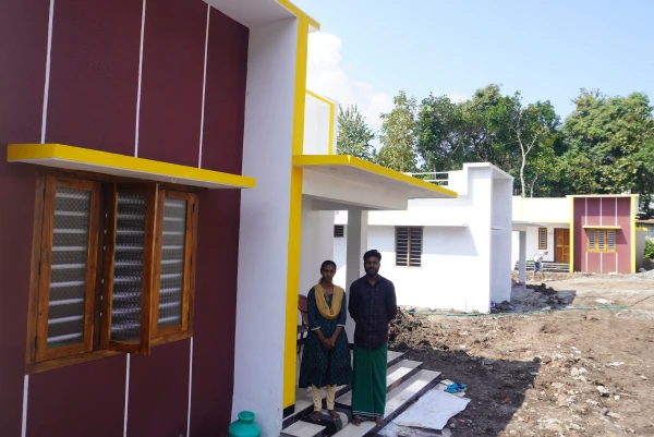 Aneesh and Sumita Rangaswami pose at their prefabricated house in Kerala State. Credit: Anto Akkara