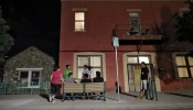 Migrant parents socialize outside the Annunciation House on June 26, 2018, in El Paso, Texas.