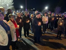 Participants pray during a peace walk in Baltimore promoted by the Archdiocese of Baltimore,  Monday, Dec. 30, 2024.