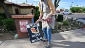 Longtime pro-life advocate Lynn Dyer places a sign that reads “Life Never a Mistake” on public property in front of Camelback Family Planning, an abortion clinic in Phoenix, on April 18, 2024.