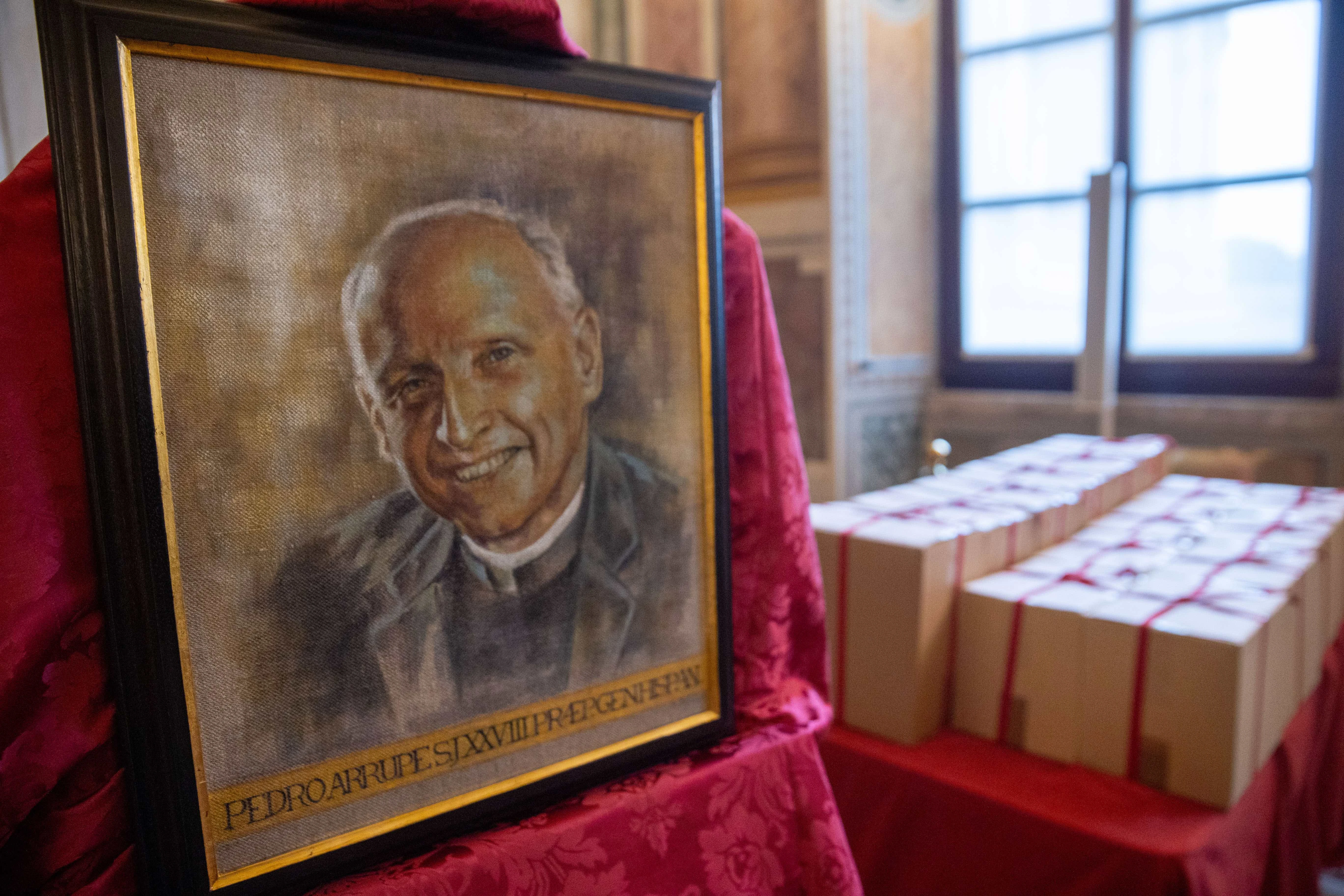 Image of Father Pedro Arrupe, SJ, beside sealed boxes of documents compiled during the diocesan phase of his canonization cause.?w=200&h=150