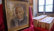 Image of Father Pedro Arrupe, SJ, beside sealed boxes of documents compiled during the diocesan phase of his canonization cause.