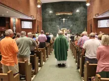 Parishioners attend a July 2024 Mass at St. Peter Church in Quincy, Illinois. This parish is one of many participating in the “Family School Agreement” meant to increase regular Mass attendance and activity among parishioners.
