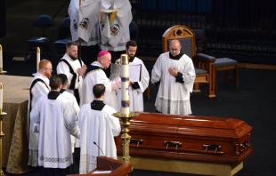 Bishop Carl Kemme of Wichita performs the absolution over the coffin of Fr. Emil Kapaun after his funeral Mass at Hartman Arena in Park City, Kan., Sept. 29, 2021. Chris Riggs/Catholic Advance