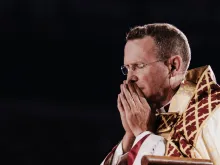 Bishop Andrew Cozzens, who spearheaded the U.S. bishops’ National Eucharistic Revival, prays in adoration of the Blessed Sacrament in Lucas Oil Stadium during the opening ceremony for the National Eucharistic Congress on July 17, 2024.