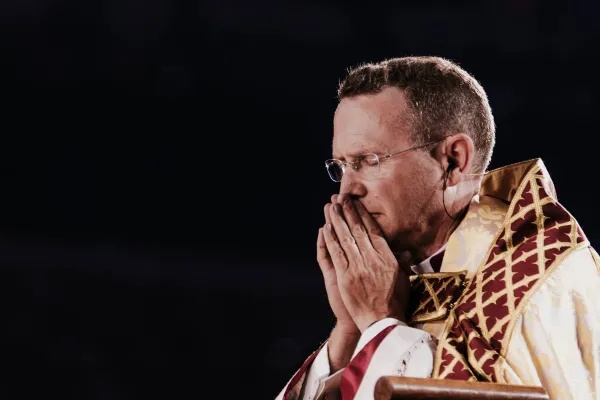 Bishop Andrew Cozzens, who spearheaded the U.S. bishops’ National Eucharistic Revival, prays in adoration of the Blessed Sacrament in Lucas Oil Stadium during the opening ceremony for the National Eucharistic Congress on July 17, 2024. Credit: Photo by Casey Johnson, in partnership with the National Eucharistic Congress.