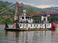 Father Roger Landry displays the Blessed Sacrament aboard the vessel "Sewickley" on the Ohio River near Steubenville, Sunday, June 23, 2024.