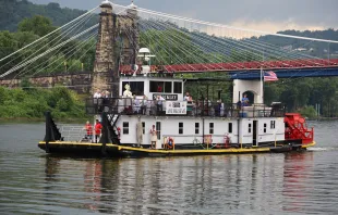 Father Roger Landry displays the Blessed Sacrament aboard the vessel "Sewickley" on the Ohio River near Steubenville, Sunday, June 23, 2024. Credit: Colleen Rowan