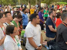 Pilgrims kneel in adoration at a World Youth Day event in Lisbon, Portugal, Aug. 2, 2023. The event was hosted by the U.S. bishops’ conference and featured a talk by Bishop Robert Barron culminating in a eucharistic procession and Holy Hour.