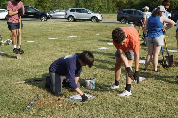 Students locate graves, remove temporary markers, and lay permanent headstones in Meadow View Cemetery in Louisville, Kentucky, Sept. 21, 2024. Credit: The Record/Ruby Thomas