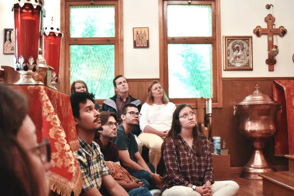 Attendees of the Byzantine Divine Liturgy sit on the floor during the homily at Holy Protection of the Mother of God Byzantine Catholic Church in downtown Denver on June 8, 2024. Credit: Kate Quiñones/CNA