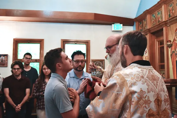 Jack Krebs receives the Eucharist during a Byzantine Catholic Divine Liturgy on June 8, 2024. The Eucharist is given via “intinction,” where the small cubes of consecrated, leaven bread are placed in the chalice and given on a spoon. Credit: Kate Quiñones/CNA