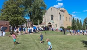 Children play as procession participants wait to enter the Shrine of St. Rose Philippine Duchesne for adoration.