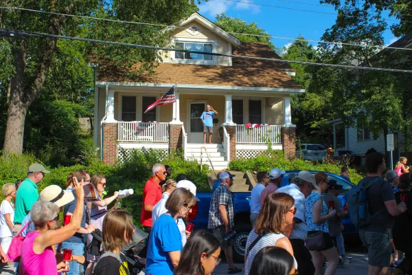A man waves from his front porch as the Eucharistic procession makes its way through the streets of St. Charles, Missouri, on its way to St. Peter Parish. Credit: Jonah McKeown/CNA