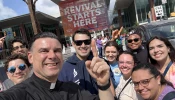 Father Rafael Capó (third from left) with young adults (from left) Alan Angelis, Arturo Zayas, Dylan Francisco, Rosanne Sherman, Cecilia Seiglie, Father Hilary Nwainya, Isabelle Seiglie, and Maria Vazquez at the National Eucharistic Congress outside of the Indianapolis Convention Center July 17, 2024.