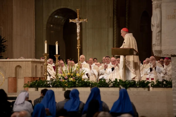 Cardinal Robert McElroy's assumption of the office of archbishop of Washington is met with applause from his fellow prelates. Credit: Patrick Ruddy/CNA