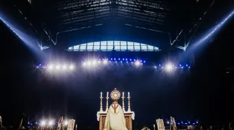 Bishop Andrew Cozzens of Crookston, Minnesota, who spearheaded the U.S. bishops’ initiative of Eucharistic Revival, adores Christ in the Eucharist with tens of thousands of people in Lucas Oil Stadium.