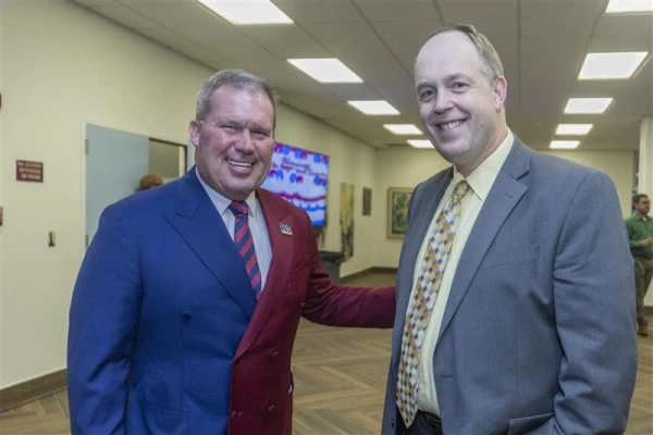 The president of St. Thomas University, David Armstrong (left), and the superintendent of Catholic schools, Jim Rigg (right), at the graduation celebration for the first Catholic Educational Leadership Cohort. Credit: Scott Gillig/St. Thomas University