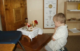 A child prays before the altar area in a Catechesis of the Good Shepherd atrium. Credit: Courtesy of CGS archives