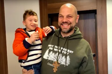 Father Jason Charron with an orphan from Ukraine.