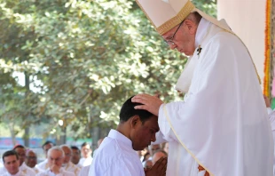 Pope Francis lays hands on a Bangladeshi deacon as he ordains him to the priesthood during a Dec. 1, 2017, Mass in Dhaka. Vatican Media.