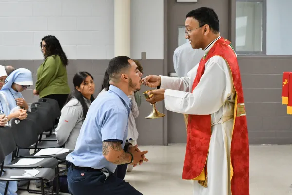 Bishop Earl Fernandes offers Communion to Hector Sandoval at Pickaway Correction Institution near Columbus, Ohio, on June 28, 2024. Credit: Catholic Times/Ken Snow