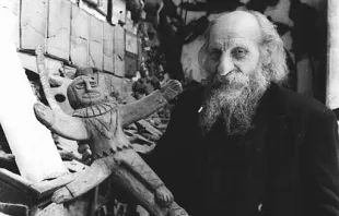 Father Carlo Crespi Croci (1891-1982) holding a crucifix from his ethnographic collection in Cuenca, Ecuador. Credit: Salesianos de Don Bosco, CC BY-SA 4.0, via Wikimedia Commons