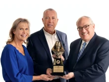 Michael P. Warsaw, chairman and CEO of EWTN Global Catholic Network, presents the 2024 Mother Angelica Award to Curtis and Michaelann Martin, co-founders of the Fellowship of Catholic University Students, on Dec. 12, 2024.