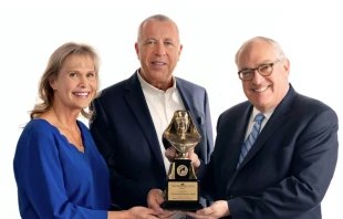 Michael P. Warsaw, chairman and CEO of EWTN Global Catholic Network, presents the 2024 Mother Angelica Award to Curtis and Michaelann Martin, co-founders of the Fellowship of Catholic University Students, on Dec. 12, 2024. EWTN