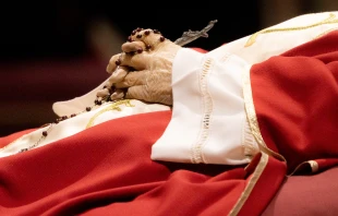 Rosary beads entwined in the hands of the late Pope Emeritus Benedict XVI as his body lies in state on Jan. 3, 2023, in St. Peter's Basilica. Daniel Ibañez/CNA